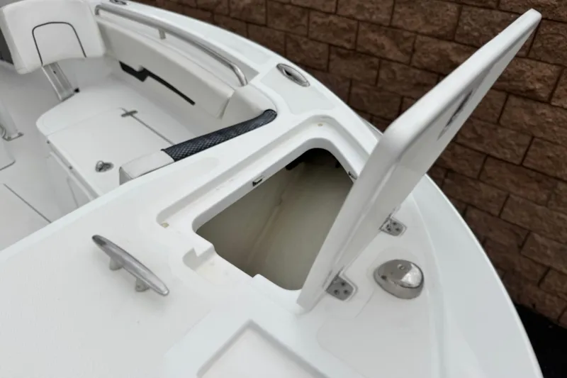 Slide: The Image of 2022 Wellcraft 222 Scarab Offshore boat with open storage compartment and seating. - 10