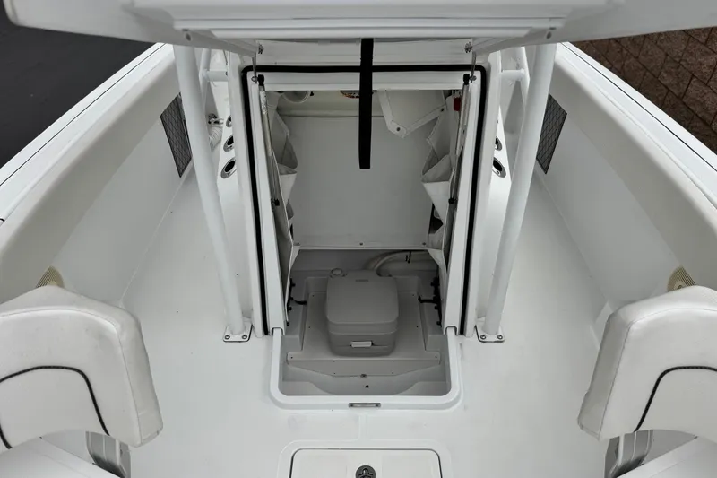 Slide: The Image of 2022 Wellcraft 222 Scarab Offshore boat interior with seating and storage area. - 17