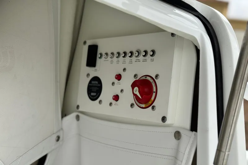 Slide: The Image of Control panel of 2022 Wellcraft 222 Scarab Offshore boat, featuring switches and a red dial. - 18