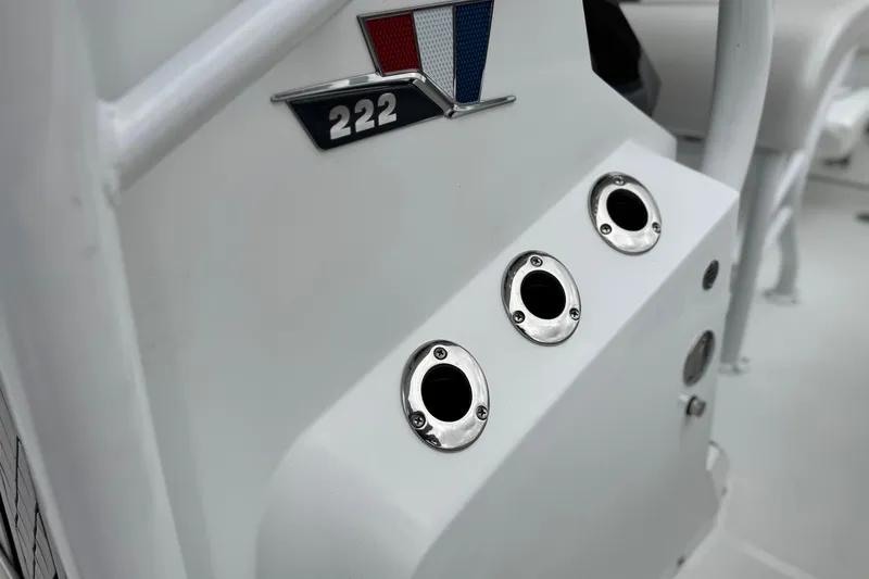 Slide: The Image of 2022 Wellcraft 222 Scarab Offshore boat dashboard with emblem and control panel. - 20