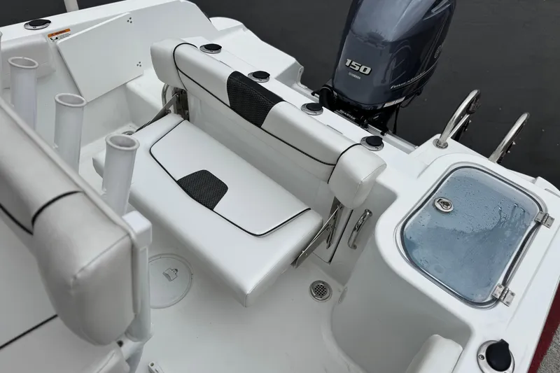 Slide: The Image of 2022 Wellcraft 222 Scarab Offshore boat interior with Yamaha 150 engine and seating. - 21