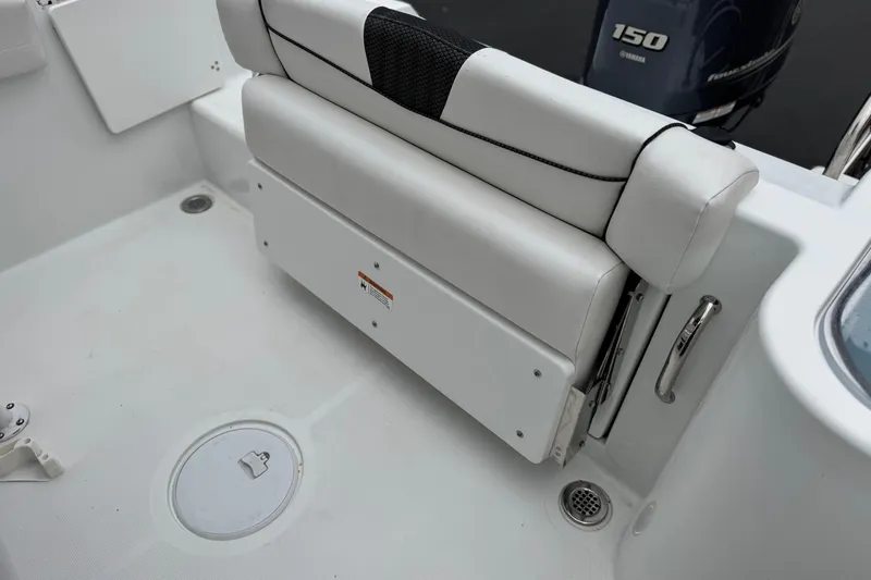 Slide: The Image of 2022 Wellcraft 222 Scarab Offshore boat interior with white seating and Yamaha 150 engine. - 23