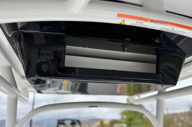 Slide: The Image of 2022 Wellcraft 222 Scarab Offshore boat console detail with warning label and mounting area. - 29