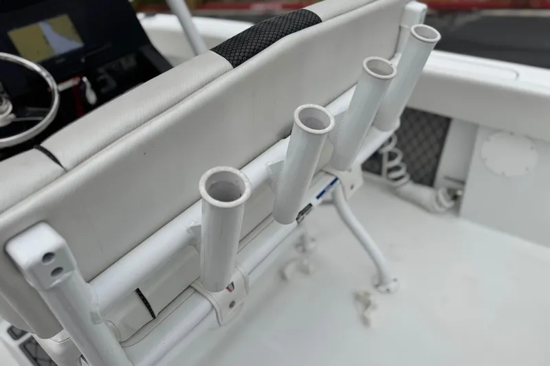 Slide: The Image of 2022 Wellcraft 222 Scarab Offshore boat interior with rod holders and steering wheel. - 30