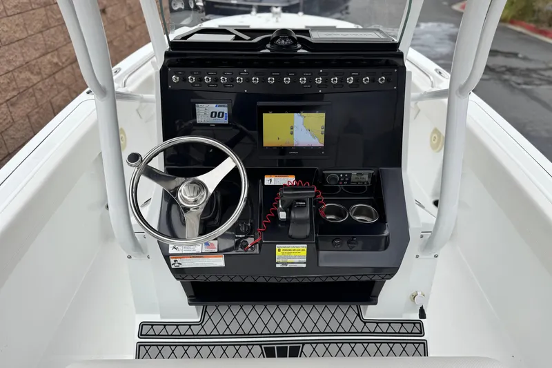 Slide: The Image of 2022 Wellcraft 222 Scarab Offshore boat dashboard with steering wheel and navigation system. - 32