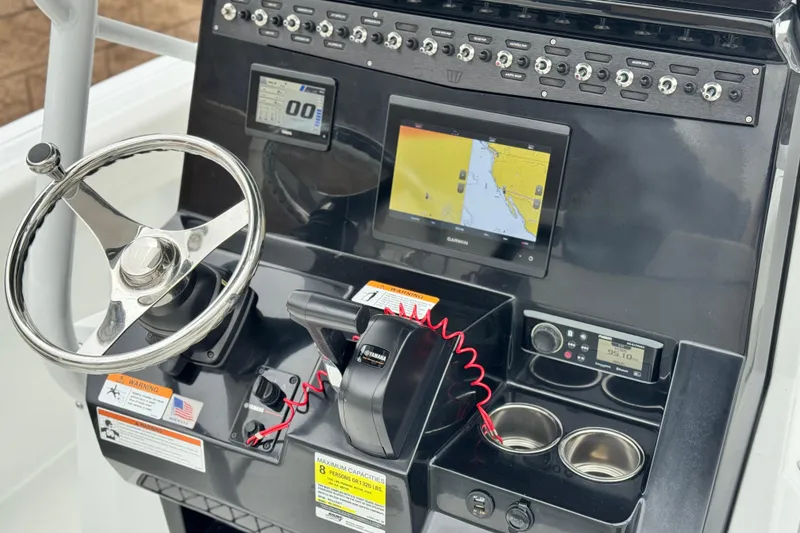 Slide: The Image of 2022 Wellcraft 222 Scarab Offshore dashboard with steering wheel, navigation, and controls. - 33