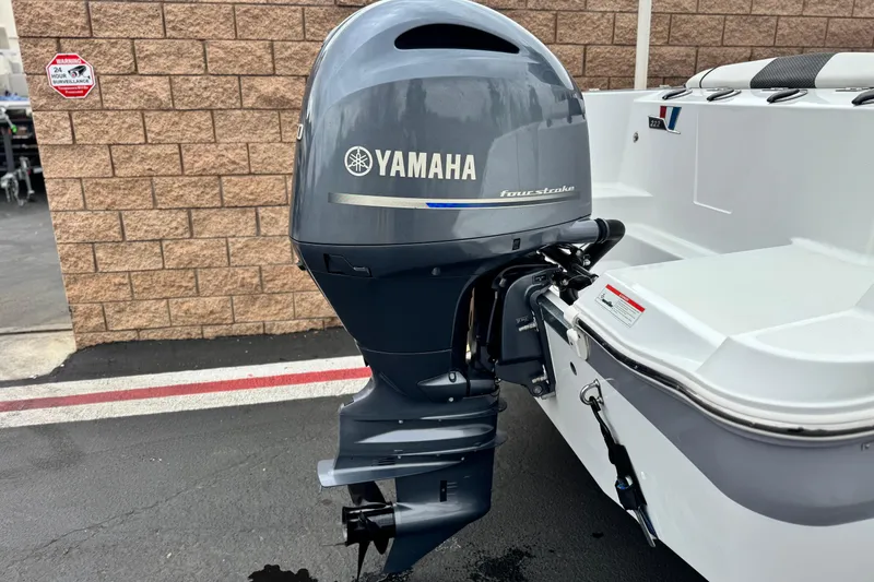 Slide: The Image of 2022 Wellcraft 222 Scarab Offshore with Yamaha four-stroke outboard motor, parked outdoors. - 6