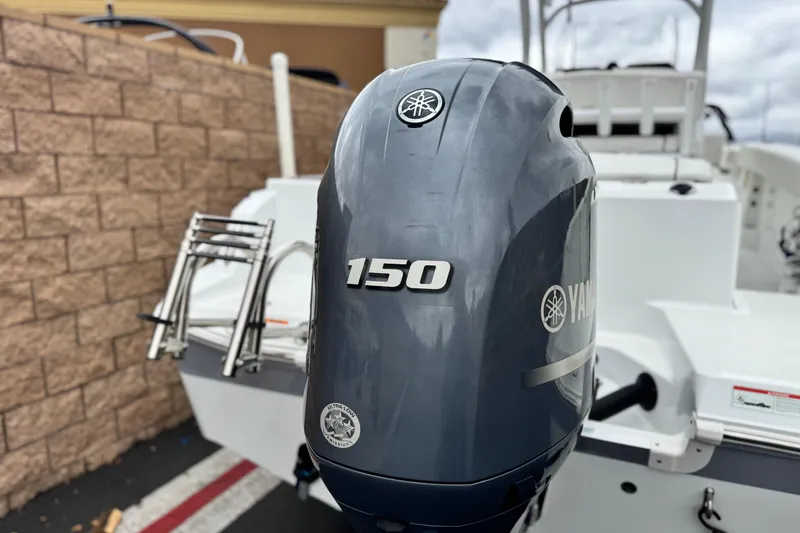 Slide: The Image of 2022 Wellcraft 222 Scarab Offshore with Yamaha 150 outboard motor, docked near brick wall. - 7