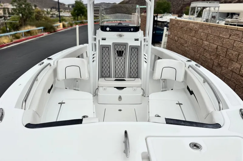 Slide: The Image of 2022 Wellcraft 222 Scarab Offshore boat interior with white seating and console. - 8