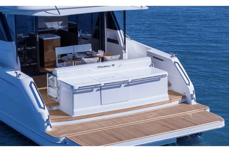 Slide: The Image of Manufacturer Provided Image: 2026 Maritimo M50 yacht with elegant deck and dining area on calm blue water. - 3