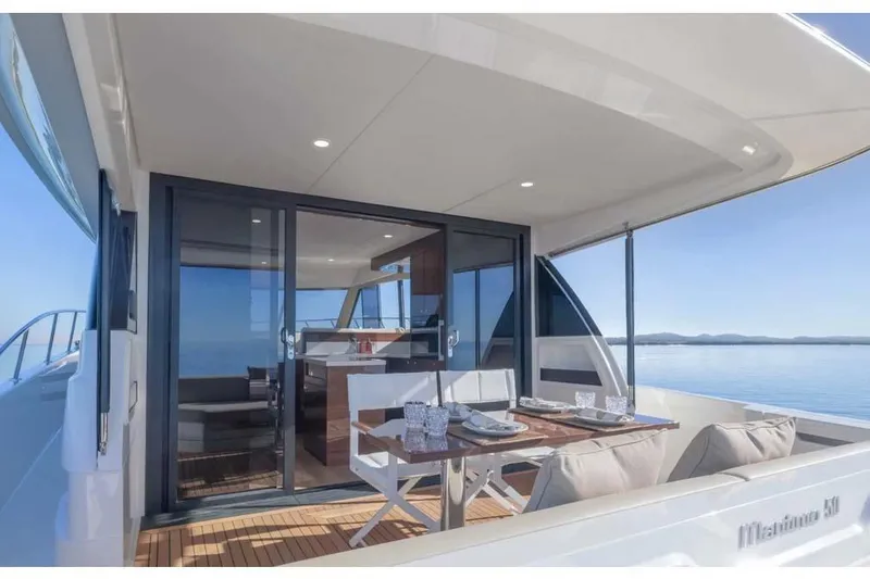 Slide: The Image of Manufacturer Provided Image: 2026 Maritimo M50 yacht with elegant outdoor dining area and scenic ocean view. - 4