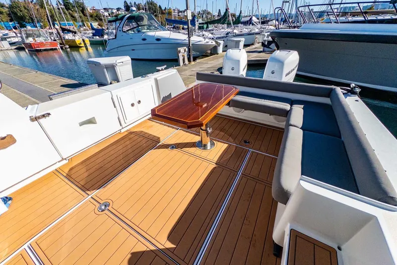 Slide: The Image of 2020 Coastal Craft 33 Express boat with spacious deck and seating at marina. - 10