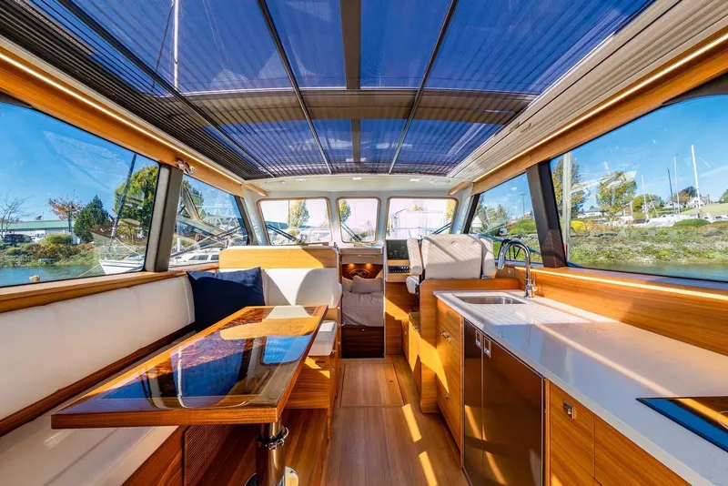 Slide: The Image of Luxurious interior of 2020 Coastal Craft 33 Express yacht with modern wood finishes and panoramic windows. - 12