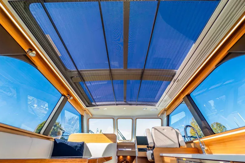 Slide: The Image of Interior view of 2020 Coastal Craft 33 Express yacht with panoramic windows and sleek design. - 13