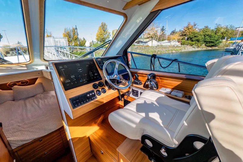 Slide: The Image of Interior of 2020 Coastal Craft 33 Express boat with helm, seating, and scenic water view. - 14