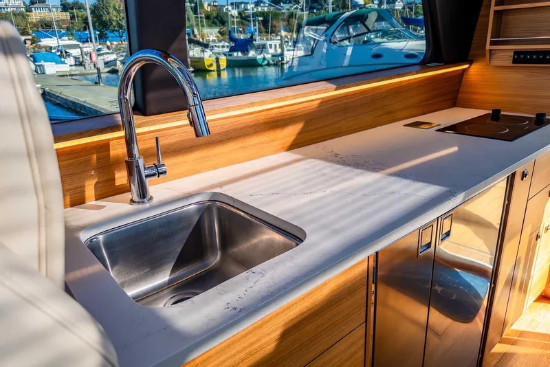 Slide: The Image of Modern kitchen interior of 2020 Coastal Craft 33 Express yacht with sink and stove. - 18