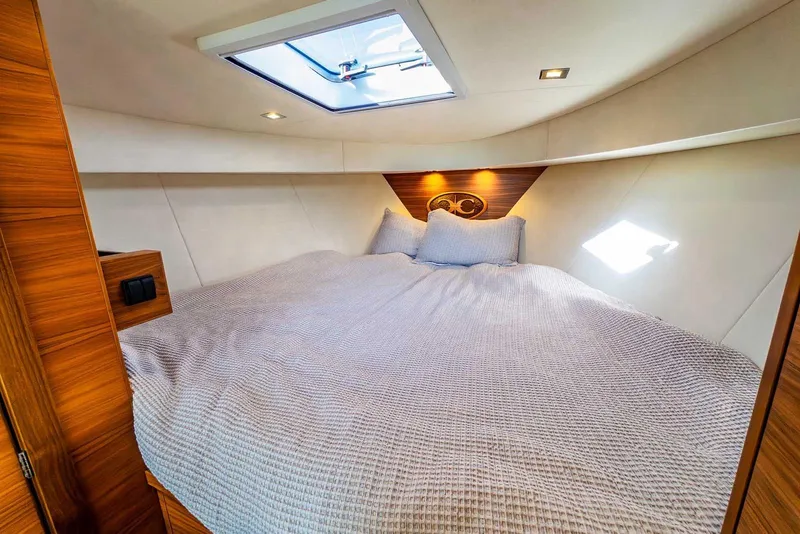 Slide: The Image of Luxurious cabin interior of 2020 Coastal Craft 33 Express yacht with skylight and cozy bedding. - 24