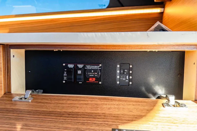 Slide: The Image of Control panel inside 2020 Coastal Craft 33 Express boat, featuring switches and indicators. - 28