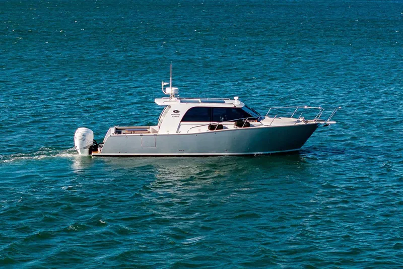 Slide: The Image of 2020 Coastal Craft 33 Express yacht cruising on open blue water. - 3