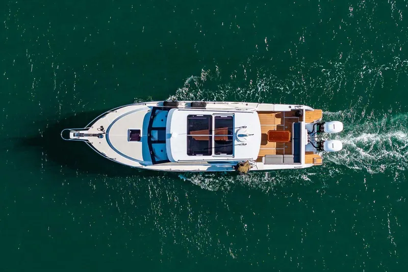 Slide: The Image of Aerial view of 2020 Coastal Craft 33 Express yacht cruising on open water. - 5