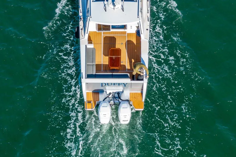 Slide: The Image of Aerial view of 2020 Coastal Craft 33 Express boat cruising on green water. - 6