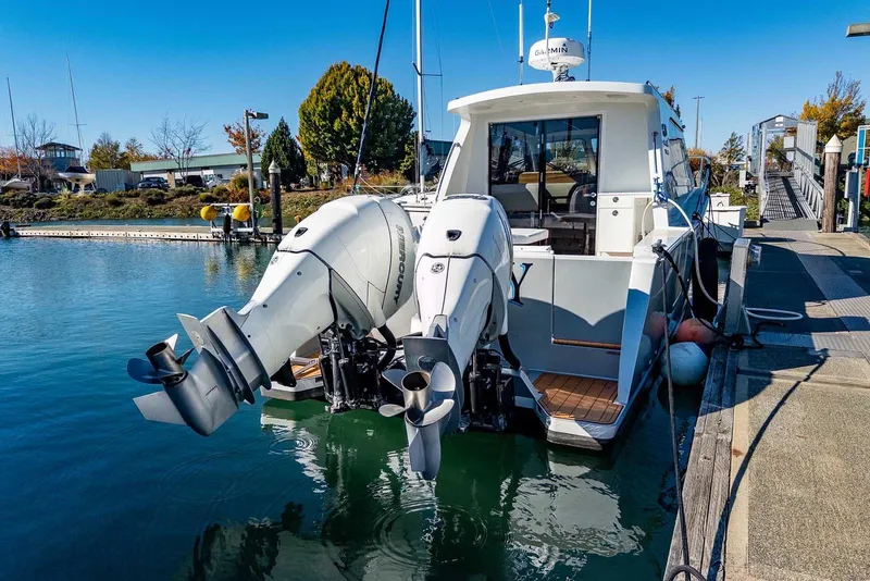 Slide: The Image of 2020 Coastal Craft 33 Express docked with dual outboard engines. - 7