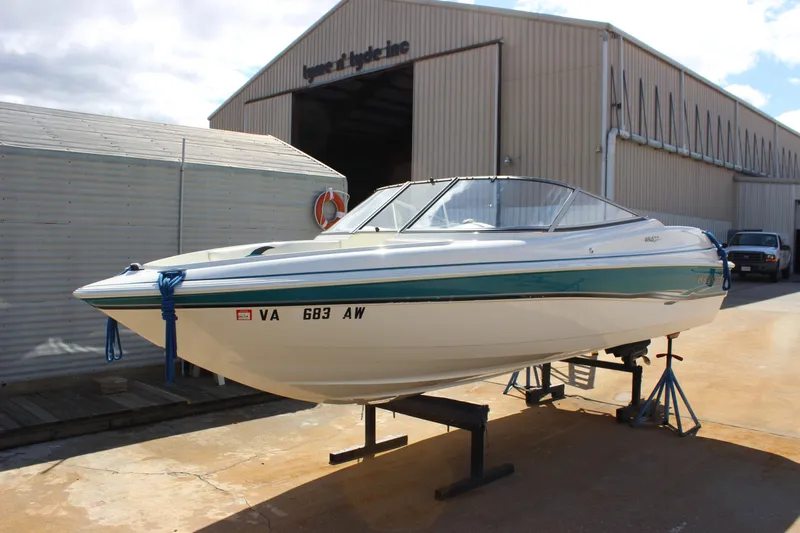 Slide: The Image of 2000 Wellcraft 186 SS/S boat on stands outside a warehouse. - 11