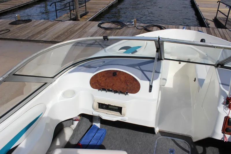 Slide: The Image of 2000 Wellcraft 186 SS/S boat interior with dashboard and seating, docked by the water. - 16