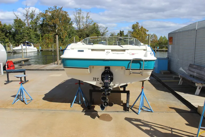 Slide: The Image of 2000 Wellcraft 186 SS/S boat on stands at a marina, rear view. - 5
