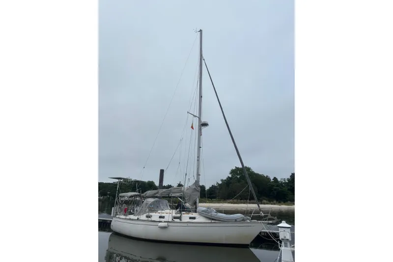 The Image of 1982 Tartan 33 sailboat docked on a calm, overcast day. - 0
