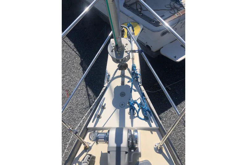 Slide: The Image of Bow view of a 1982 Tartan 33 sailboat with deck equipment and rigging. - 11