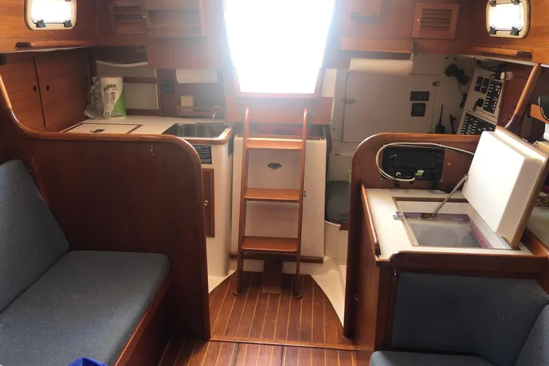 Slide: The Image of Interior of 1982 Tartan 33 sailboat with wooden cabinetry and seating. - 16