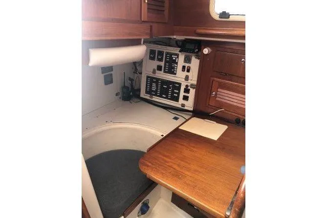 Slide: The Image of 1982 Tartan 33 sailboat interior with navigation station and wooden cabinetry. - 23
