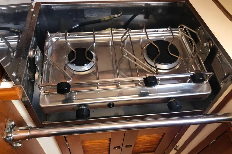 Slide: The Image of 1982 Tartan 33 yacht kitchen with a two-burner stainless steel stove. - 29