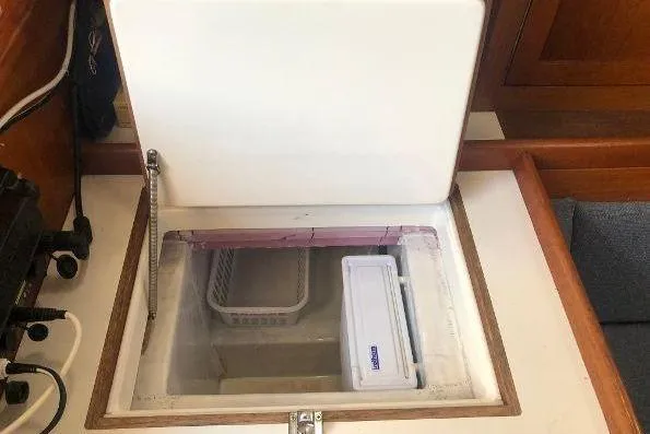 Slide: The Image of 1982 Tartan 33 yacht interior with open storage compartment. - 31