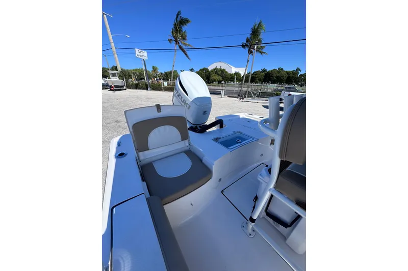 Slide: The Image of 2026 Sea Born FX22 Bay boat interior with seating and Suzuki outboard motor. - 10