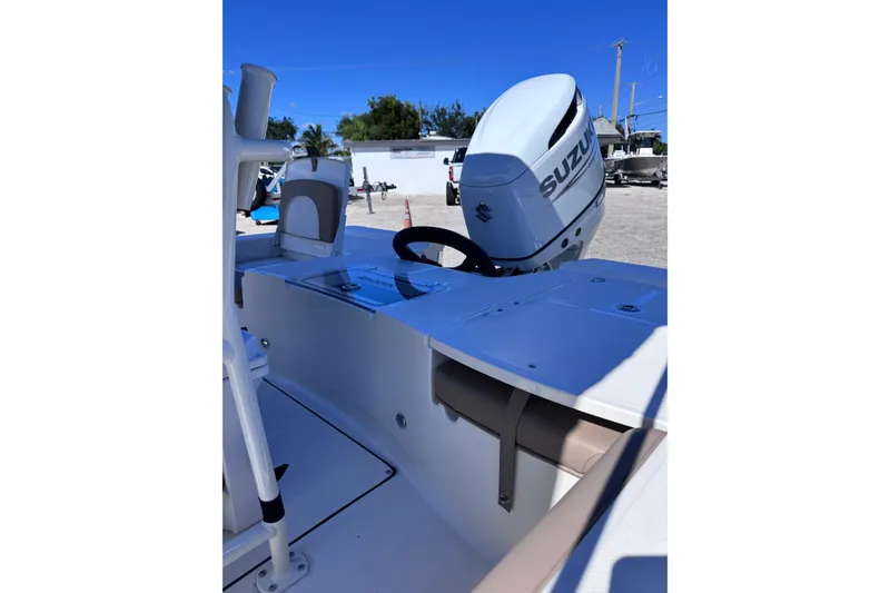 Slide: The Image of 2026 Sea Born FX22 Bay boat with Suzuki outboard motor, docked under clear blue sky. - 11