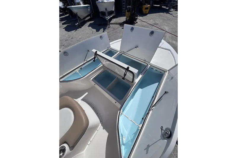 Slide: The Image of 2026 Sea Born FX22 Bay boat with open storage compartments on deck. - 18