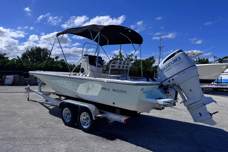 Slide: The Image of 2026 Sea Born FX22 Bay boat with Suzuki outboard motor on trailer. - 2