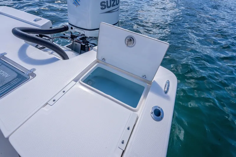 Slide: The Image of 2026 Sea Born FX22 Bay boat with open storage compartment on water. - 20