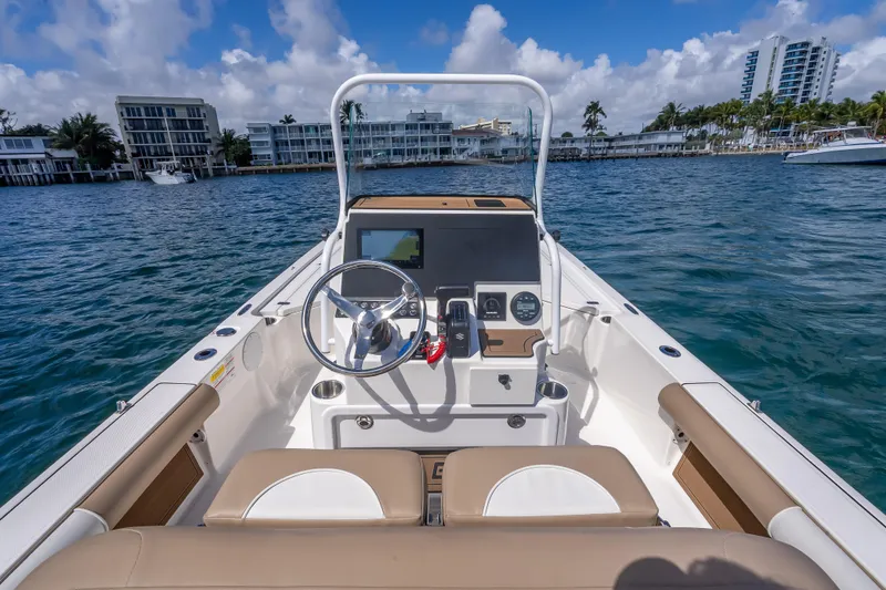 Slide: The Image of 2026 Sea Born FX22 Bay boat interior with steering wheel, dashboard, and waterfront view. - 25