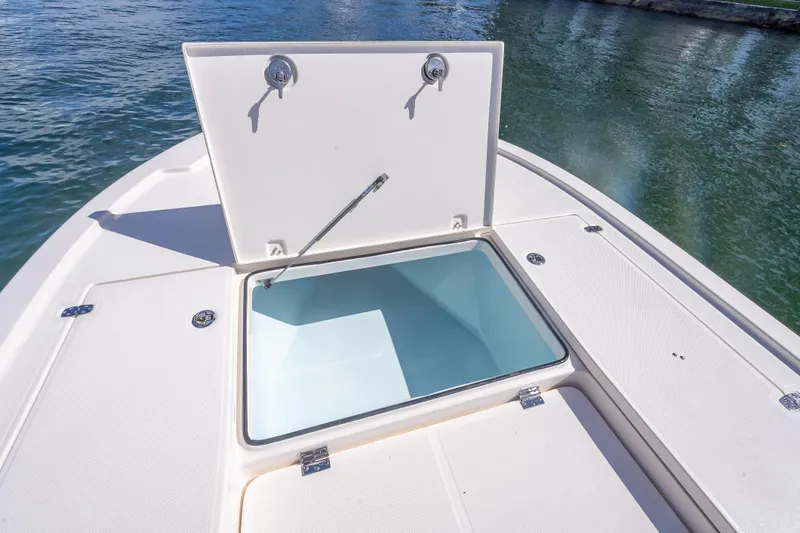 Slide: The Image of Open storage compartment on 2026 Sea Born FX22 Bay boat, docked on water. - 30