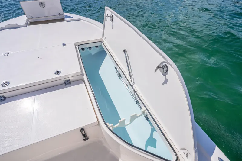 Slide: The Image of Open storage compartment on 2026 Sea Born FX22 Bay boat, near water. - 32