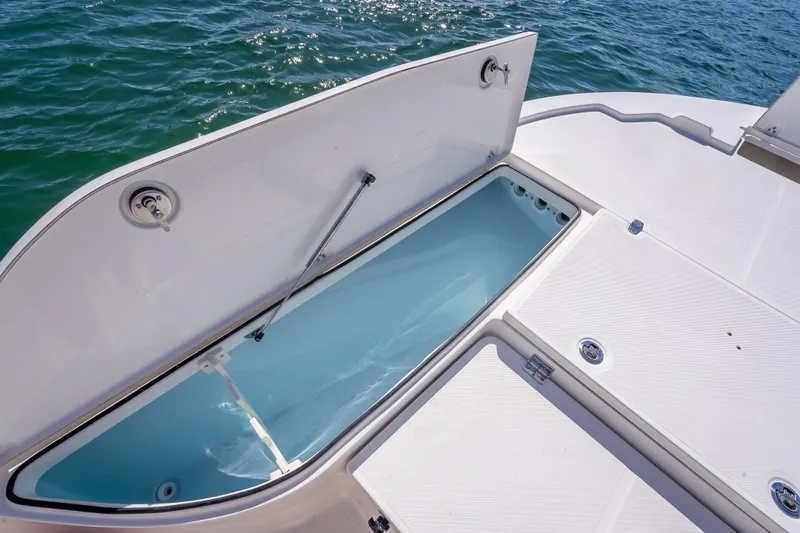 Slide: The Image of Open storage compartment on 2026 Sea Born FX22 Bay boat, near water. - 33
