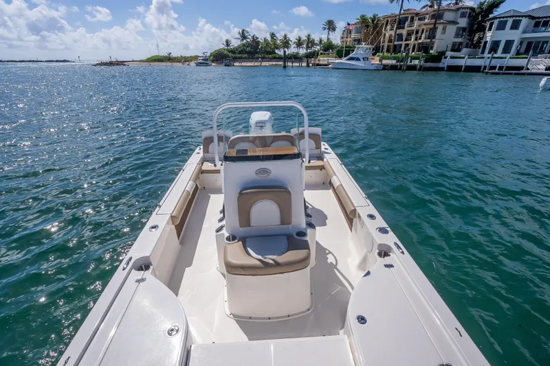 Slide: The Image of 2026 Sea Born FX22 Bay boat on calm waters near luxury waterfront homes. - 37