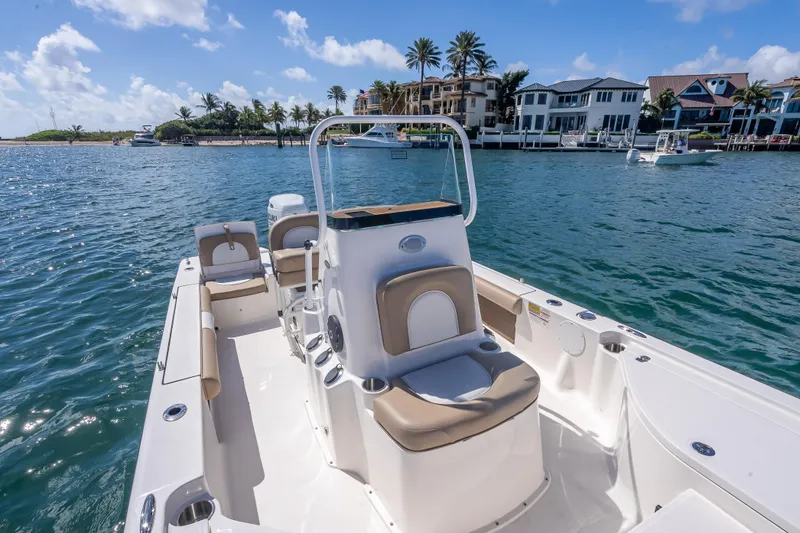 Slide: The Image of 2026 Sea Born FX22 Bay boat on calm water near luxury waterfront homes. - 38