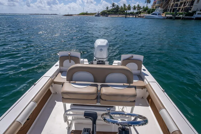 Slide: The Image of 2026 Sea Born FX22 Bay boat on calm waters, featuring a sleek interior design. - 40