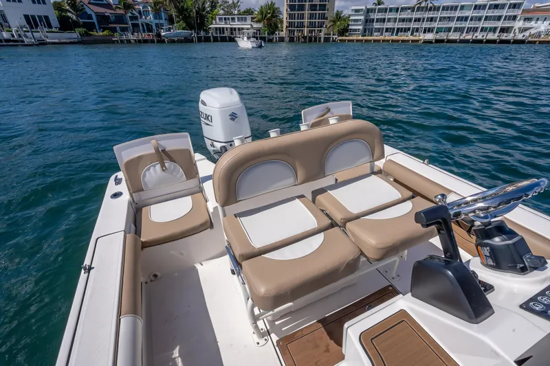 Slide: The Image of 2026 Sea Born FX22 Bay boat interior with tan seating and Suzuki outboard motor. - 41
