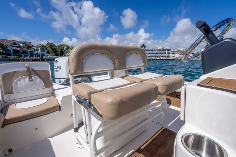 Slide: The Image of 2026 Sea Born FX22 Bay boat interior with beige seating, steering wheel, and waterfront view. - 42