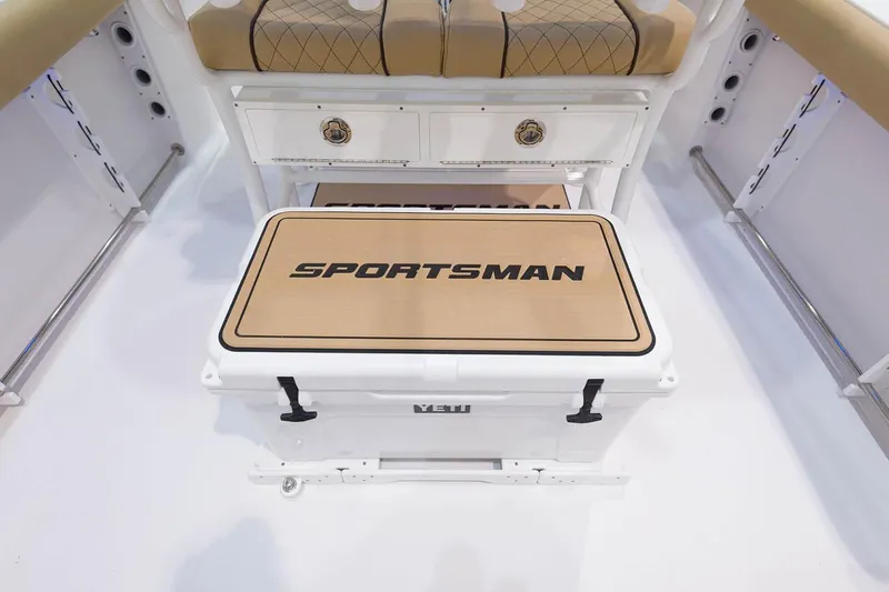 Slide: The Image of Trailer wheels of a 2023 Sportsman Open 232 Center Console on gravel and grass. - 13